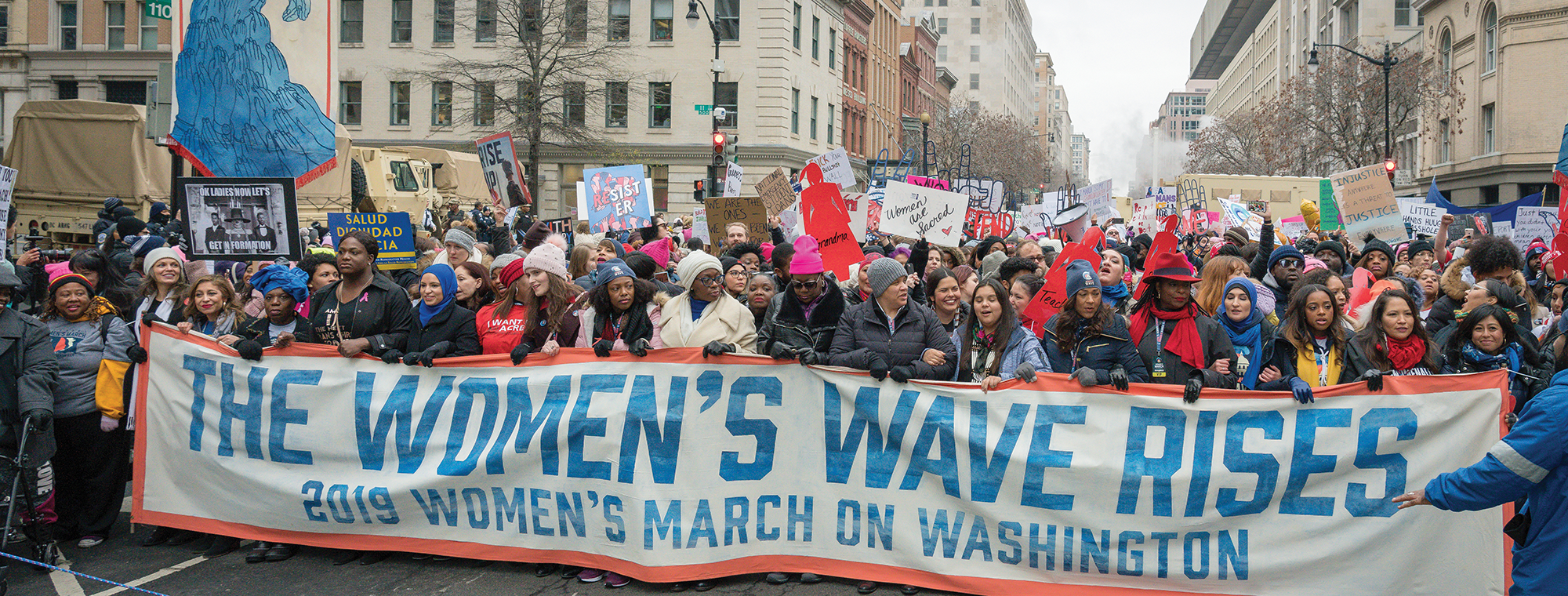 Marchers carrying the 'women's wave' sign at the 2019 Women's March, Washington, DC. Image: Mobilus In Mobili, Flickr