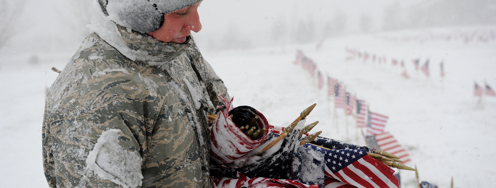 US Air Force Tech. Sgt. Sara Bauer, 388th CMS, holds a bunch of American flags during a volunteer opportunity at the Veterans Memorial Park, Bluffdale, Utah, Nov. 9, 2012